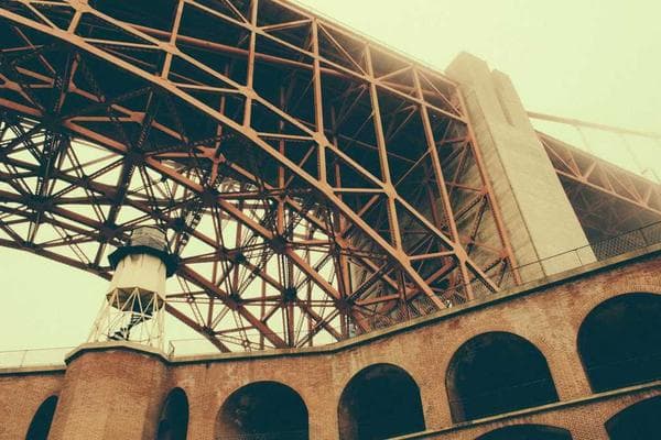 A student studying at a desk with a laptop and books